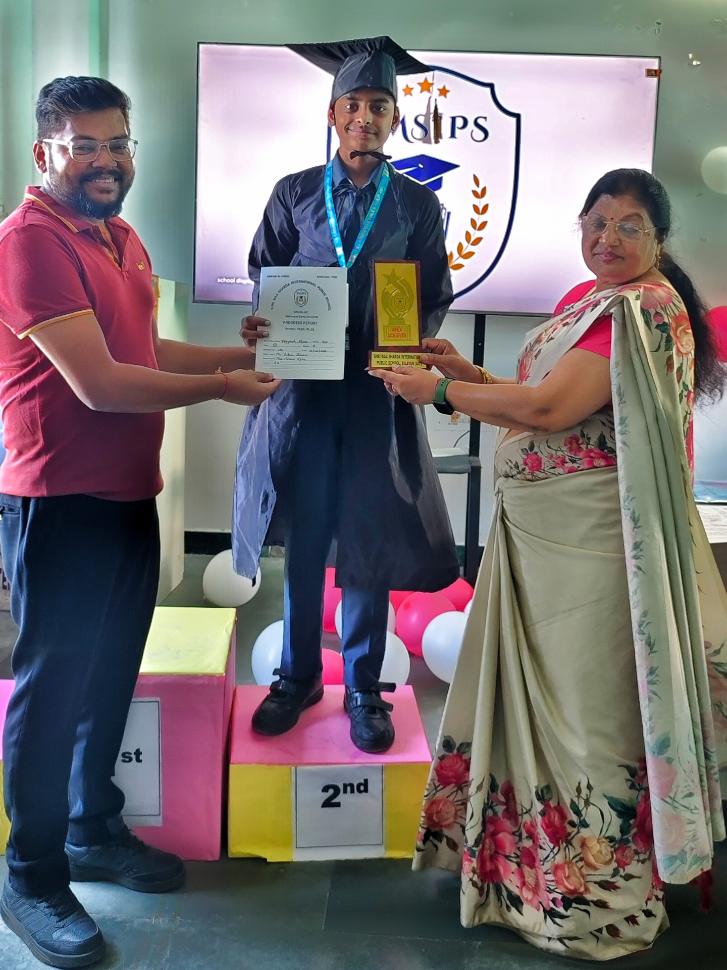 Bipin Sir celebrating student success with a certificate and award